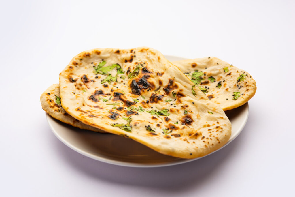 Delicious Tandoori Naan baked with traditional way using blistering tandoor oven at Tandoori Bliss Adelaide (Australia)